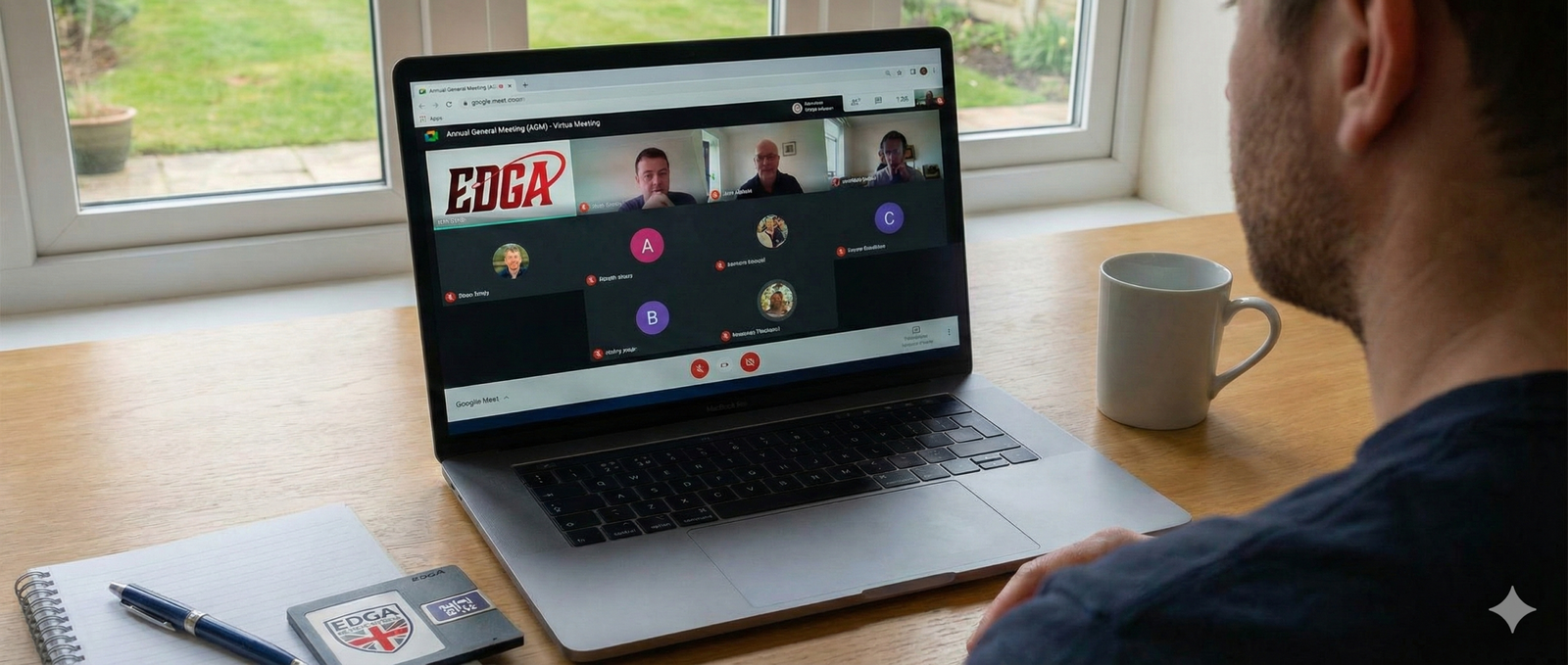 A professional home office desk featuring a laptop screen displaying a Google Meet video call with several diverse participants. On the desk, there is a physical disc golf disc featuring the red EDGA logo, a notebook with minutes, and a mug. Through the window, a disc golf basket is visible on a green park fairway, clearly identifying the sport.